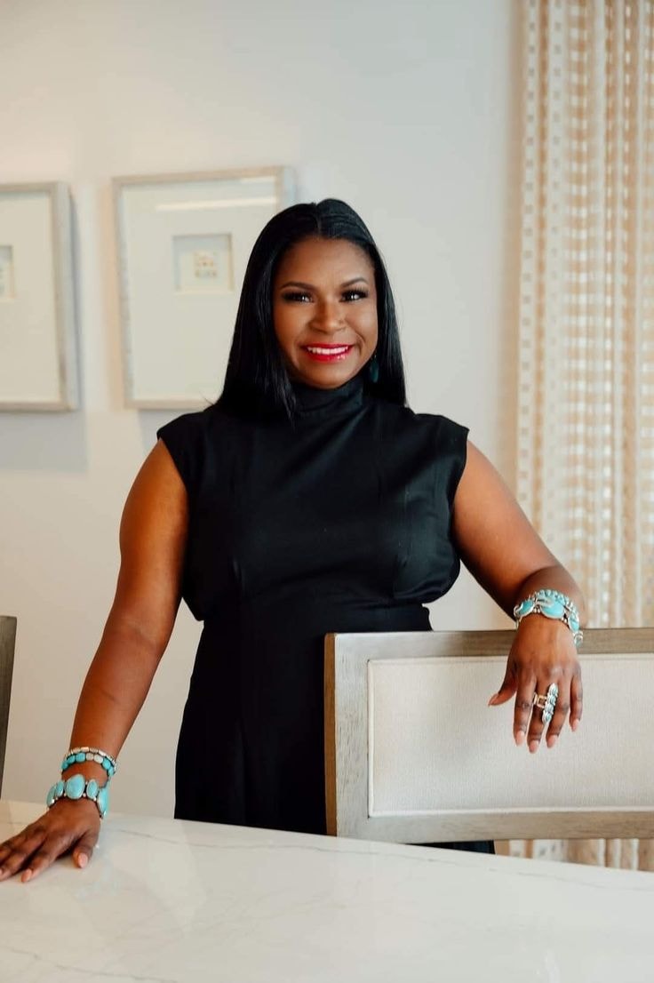 Josette — black turtleneck dress, turquoise bracelets and rings, office setting