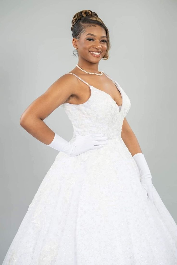 Kennedy — black wide-leg set, tan hat, white studio chair