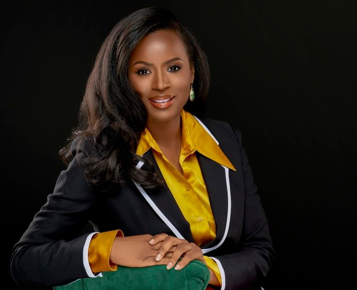 Lindsey — black blazer, gold mustard shirt, dark background