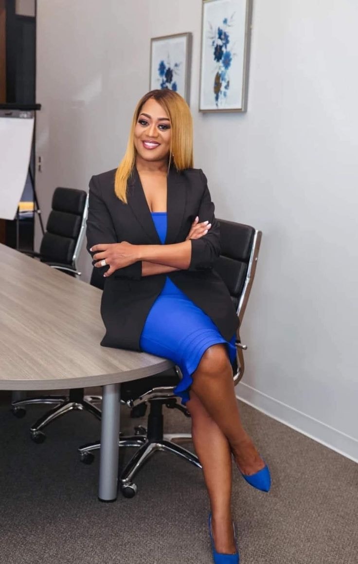 Raven — black blazer, cobalt blue dress, boardroom