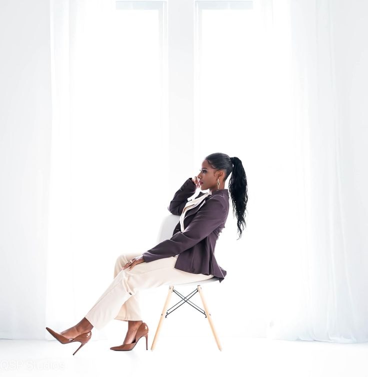 Regina — mauve blazer, seated on chair, profile