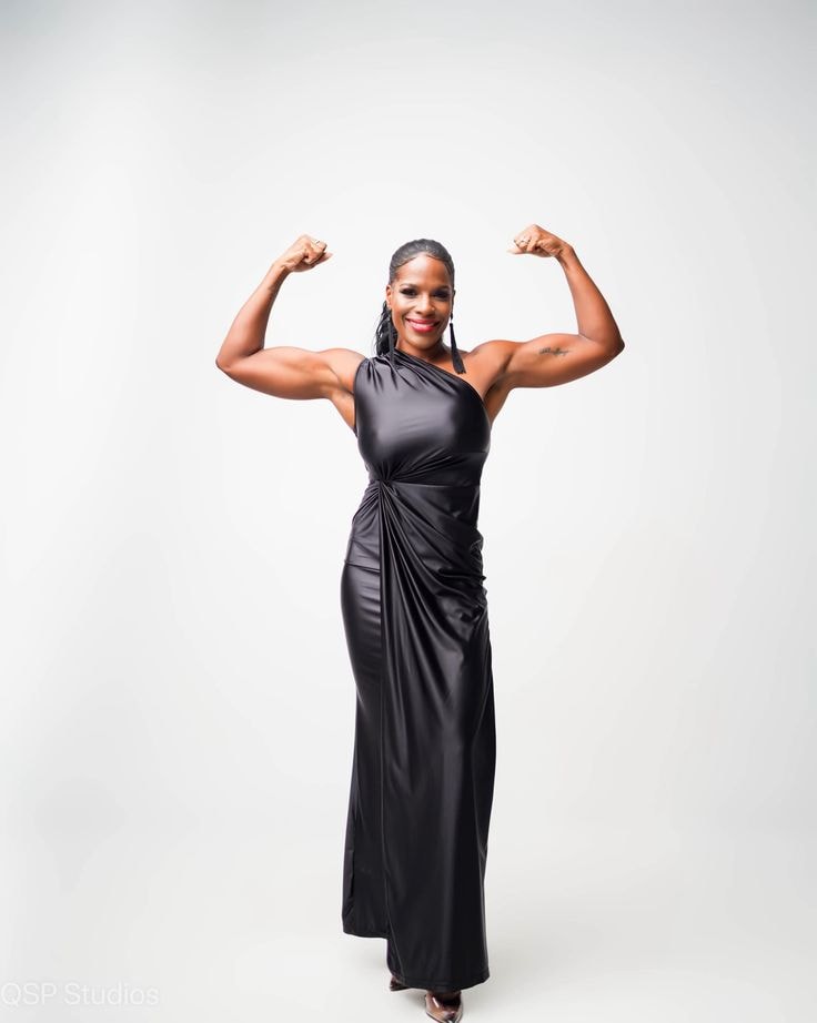 Regina — black one-shoulder gown, flexing, full length